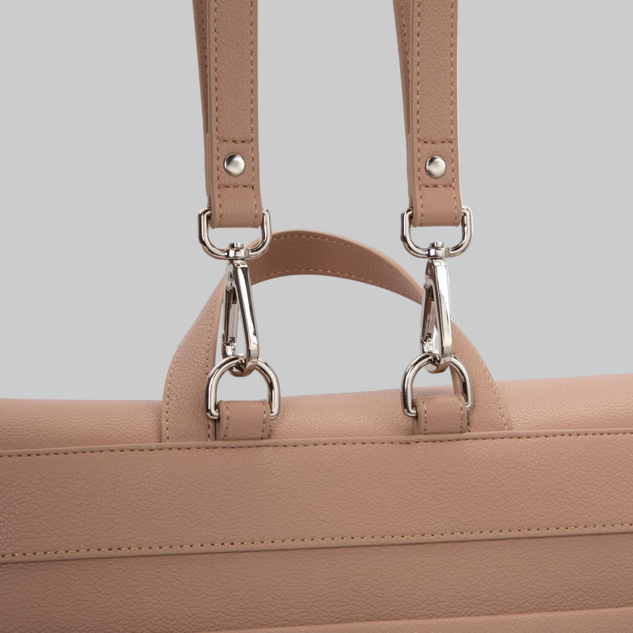 Kalos Luxe Rosey Taupe diaper bag with detachable silver hooks to carry bag as a shoulder bag or back pack.